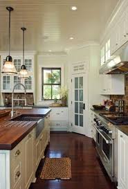 For example, even something as simple as the white veining on the black countertop and backsplash. Dark Stained Wood Floors And Butcher Block Countertops Warm Up The White Ceiling Cabinets And Walls Rustic Country Kitchen Decor Home Rustic Country Kitchens