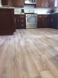 Whitewashed floors and white cabinetry look modern and chic together. Restaining Finishing Hardwood Floor What Works With Cherry Cabinets
