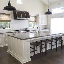 Antique white kitchen island with dark brown quartz tops center. Gray Quartz Top Kitchen Island With Black Vintage Barn Pendants Transitional Kitchen
