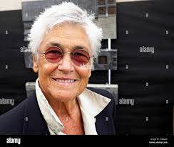 A middle-aged woman with very short hair wearing tinted glasses. She is  artist Grayson Malone Stock Photo
