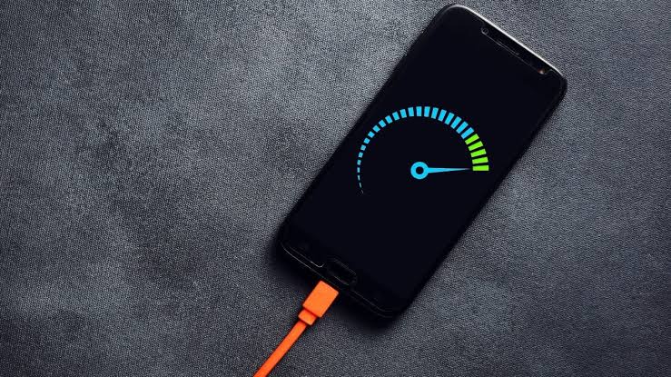 Smartphone plugged in and charging with a speed indicator on screen
