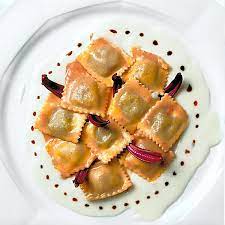 Preparate in casa la pasta per i ravioli e farciteli con un ripieno di radicchio saltato in padella, 1 uovo, 4 cucchiai di parmigiano grattugiato, sale e pepe; Ravioli Al Radicchio Tardivo Di Treviso Speck E Formaggio Di Fossa Strada Del Radicchio