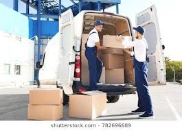 delivery men unloading moving boxes from car