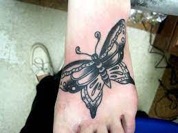 Daisy flower tattoo on toe. Traditional Butterfly Butterfly Tattoo On Foot Butterfly Tattoo Tribal Butterfly Tattoo