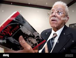 FILE** James Cameron holds his book "A Time For Terror" in the Black  Holocaust Museum in Milwaukee Jan. 28, 2003. Cameron, the founder the  museum, who survived an attempted lynching by a