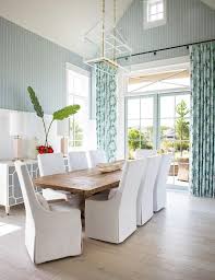 Charming White And Blue Dining Room Features White Slipper Dining Chairs Placed Around A Recl Reclaimed Wood Dining Table Cottage Dining Rooms Dining Room Blue