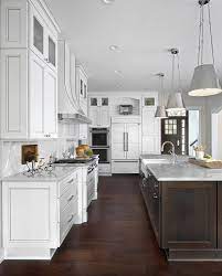 White and marble wall kitchen interior with a wooden floor, green closets and countertops, and a fridge. Large White Kitchen Boasts An Exquisite Dark Brown Island Topped With White Marble Countertops Hol Kitchen Cabinet Design Diy Kitchen Renovation Kitchen Design