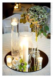 Tall Clear Glass With Tea Lights Floating Other Candle In A Hurricane Shade Smaller Ones In Diff Wedding Flower Arrangements Wedding Table Wedding Flowers