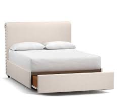An upholstered bed with an upholstered headboard steals the show in this elegant space by jodie rosen design. Chesterfield Upholstered Bed With Footboard Pottery Barn