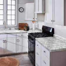 The silver schluter trim/edging was used instead of the matching trim pieces that many tile manufacturers make for their backsplash tile. Hampton Bay 6 Ft Cream Laminate Countertop With Eased Edge In White Ice Granite With Backsplash 011349010609476 The Home Depot