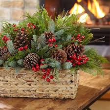 Christmas Arrangement Of Greenery Pinecones And Red Berries In A Basket Christmas Floral Arrangements Christmas Flower Arrangements Christmas Centerpieces