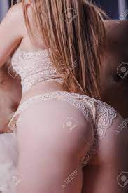 Beautiful Blonde Girl In Delicate Beige Lace Underwear Bent Over On A Brown  Sofa Rear View Closeup Priests Stock Photo, Picture and Royalty Free Image.  Image 134835180.