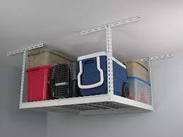 These overhead hanging storage shelves hide the mess with sliding doors! Overhead Garage Storage Ideas For Your Vertical Space