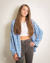 The event was all about embracing and loving natural hair. Portrait Of A Beautiful Teenage Girl In A White Top And Blue Shirt With Long Brown Hair Isolated Against A Light Grey Background Wearing Grey Trousers Stock Photo Picture And Royalty Free