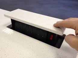 Many manufacturers make outlets that blend in or that can be painted or wallpapered, in the case of smoothline (shown here). S Box Pop Up Power Sockets Available In A Wide Range Of International Sockets Kitchen Island Sockets Kitchen Outlets Pop Up Outlets