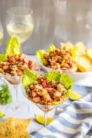 Place the shrimp cocktail in small individual bowls or cocktail glasses filled with ice cubes or crushed ice, leaving just enough room in the glass for a place a layer of ice on the bottom of a deep serving tray and place shredded lettuce or cabbage over the ice to conceal it and to add to the presentation. Shrimp Martini Appetizer Family Food On The Table