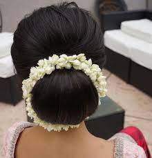 Obsessing Over This Updo Textured Volume With A Smooth Bun Oh And Fresh Jasmine Flowers Up Bridal Hair Buns Bridal Bun Hairstyles Low Bun Hairstyles