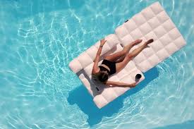 Steel outdoor floating chaise lounge chair with teal cushion. Is This 450 Inflatable Lounger The Porsche Of Pool Floats Wsj