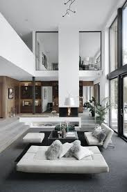Scandinavian Living Room With A High Ceiling And Big Windows Grey And White Colors With Wood De Interior Design Living Room House Interior Modern House Design