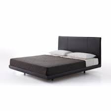 This ottoman serves as a footstool or as a coffee table. Sadoru Bed By Porro