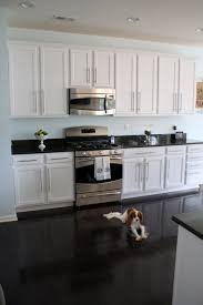 David snazel, buyer at carpetright explains more, 'kitchens are at the heart of most homes and usually see a lot of traffic, so it's best to opt for high quality, durable flooring that is low maintenance and will stand the test of time.' Kitchen Cabinet Black Kitchen Cabinets Dark Floors Simple Beautiful Kitchen Design