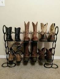 Traditional cowboy boots have narrow toes, high heels that slope under the foot, and leather tops that reach halfway up the shins. 120 Cowboy Boots Racks Ideas In 2021 Boot Rack Horseshoe Projects Horseshoe Art
