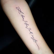 This man has got his name inscribed on his forearms in cold and cursive font couple script tattoo. Untitled