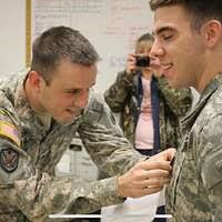 Lt. Jacqueline Pollock, of Central City, Pa., guides Master-at-Arms 1st  Class Heath Forney through a back exercise demonstration during a Back  Safety Fair