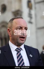 Mark Tipper (centre), the brother of Trooper Simon Tipper, a victim of the  Hyde Park bombing, outside the High Court in London after the families of  the Hyde Park bombing victims won