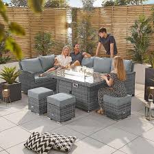 Patio with wood table set and heat lapm. Cambridge Fire Pit Patio Furniture Set