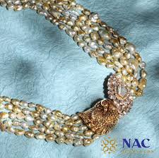 Traditional bridal heavy necklace with lakshmi design , studded with kundans and rubies, paired up with kundan bangles set and jhumkas. Kundan Chokers By Nac Jewellers Jewellery Designs