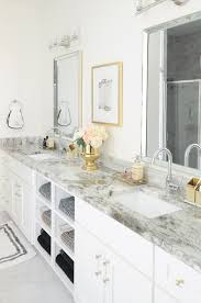 In this bathroom, white coats every surface, except the wood vanity, to maximize the bright, expansive effect. Glam Gold White Master Bathroom Refresh Monica Wants It