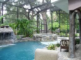 Beach Entry Pool Faux Log Lanai Post And Waterfall With Rock Spa And Beach Entry All Enclose Indoor Swimming Pool Design Indoor Swimming Pools Beach Entry Pool