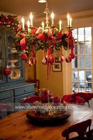 Festive Way To Dress Up A Chandelier Add Garland And Ribbon And Hang Ornaments From The Branches Christmas Chandelier Christmas Decorations Christmas Deco