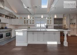 Here, earth tones blend with formal furniture and the oversized central island encourages conviviality. White Inset Kitchen With Oversized Island Norfolk Kitchen Bath