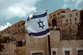 It depicts a blue hexagram on a white background, between two horizontal blue stripes. Izrail S 23 Maya Nachnet Prinimat Pervyh Inostrannyh Turistov Avianews Com