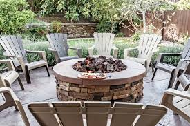 This wood burning fire pit conveniently features an opening that provides easy access to the fire to keep it going during outdoor gatherings. Outdoor Fireplace Fire Pit Landscaping Patio Builders Mckinney Outdoor Kitchens