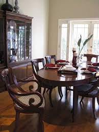 Black and white dishes and curvy ceramic vases in black and gray accent the piece further. Tropical British Colonial Style Colonial Dining Room British Colonial Dining Room Colonial Dining Room Furniture