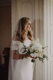 Bouquet of white roses and wedding shoes on chair. Peonies Magnolias And Protea 11 Beautiful White Bridal Bouquets