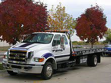 They have the plane in tow and will bring it back to the hangar. Flatbed Truck Wikipedia