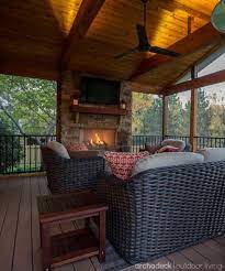 This Screen Porch Displays Comfort And Warmth With Up Lighting The Glow Of A Fireplace And The Rich W Porch Fireplace House With Porch Screened Porch Designs