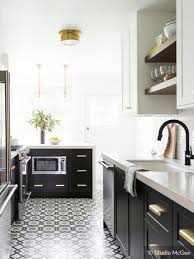 Black And Gold Kitchen Floor Tiles These Black White And Gold Appliances Mimic The Colors In The Floor Tile Creating Harmo Kitchen Design Trends Kitchen Remodel Kitchen Cabinets And Backsplash