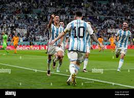 Argentina's Nahuel Molina, left, celebrates with Lionel Messi, back to  camera, after scoring the opening goal during the World Cup quarterfinal  soccer match between the Netherlands and Argentina, at the Lusail Stadium