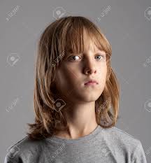 The sleeves get larger as they reach luck's hands, making the tunic appear loose. Portrait Of A Boy With Long Blond Hair Isolated On Gray Stock Photo Picture And Royalty Free Image Image 88673030