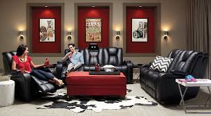 A black living room filled with a huge velvet sofa and ottoman. Black Gray Red Living Room Furniture Decorating Ideas