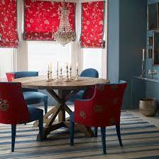 The room is lighted by a glamorous chandelier. Classic Red And Blue Dining Room Dining Room Design Ideal Home Dining Room Blue Dining Room Style Dining Room Design Modern