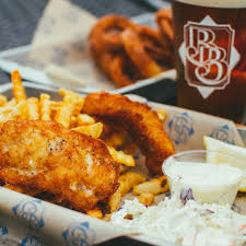 Crispy cod medallions on a bed of shredded cabbage with a chili lime allioli. The Best Fish And Chips In Whatcom County