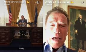 Arnold Schwarzenegger sits at replica of Richard Nixon's desk at the Oval  Office
