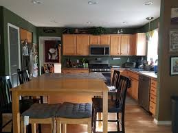 Not only does it blend with them, thanks to its warm beige nature, but the purple helps to downplay some of the orange in the oak cabinets, trim or flooring. Wall Paint Color For Oak Cabinets And Oak Floor