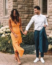 A Gorgeous Sunny Yellow Midi Dress With An Asymmetric Ruffled Skirt A Deep V Neckline And No Sl Guest Attire Summer Wedding Outfits Beach Wedding Guest Attire